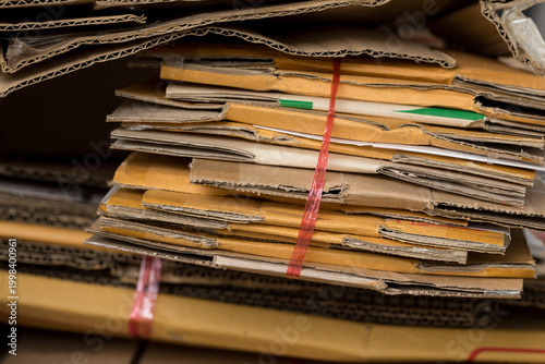 Stack of folded cardboard boxes neatly arranged for recycling, eco-friendly concept, waste management and sustainability