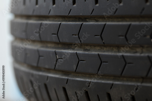 Close-up of worn-out car tire with tread wear, old rubber surface showing signs of usage and deterioration, automotive maintenance and safety concept