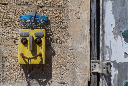Creative street art piece made of recycled materials on a textured stone wall