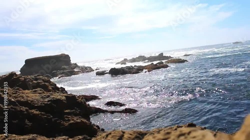 Calm Ocean Over Flat Coastal Rocks at Evening – Gentle Waves Flowing Across Rocky Shoreline, Warm Sunset Light, Peaceful Seaside Landscape, Natural Beach Scene 4K Footage