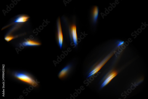 Abstract rainbow light leaks overlay on black background for photo editing. Prism flare effect used to add glow, light leaks and cinematic atmosphere to images