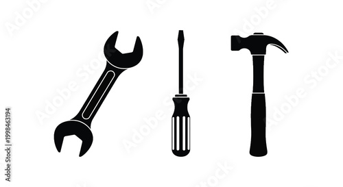 Black silhouettes of a wrench screwdriver and hammer on white background