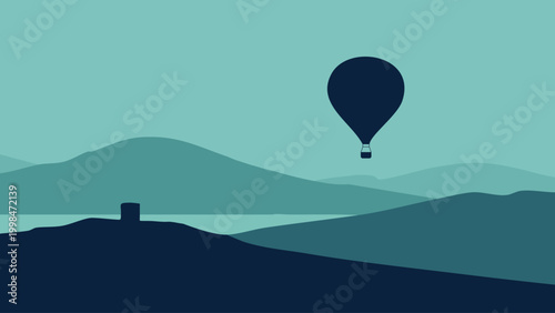 Hot air balloon silhouette against layered mountain landscape