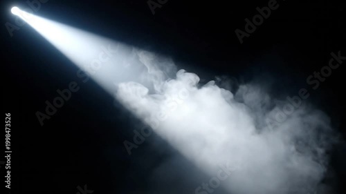 Dramatic spotlight beam shining through swirling white smoke