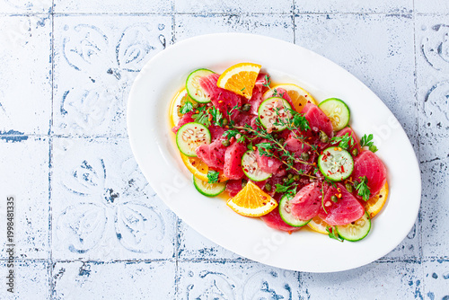 Sicilian tuna crudo, on a white plate, Italian dish, homemade, no people,
