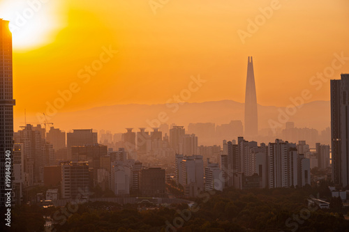 Gold sun risae or sunset of Seoul cityscapes with high rise office buildings and skyscrapers in Seoul city, Republic of Korea in winter golden yellow sky and cloud