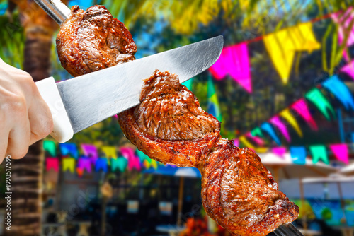 a skewer, featuring traditional colorful Festa Junina flags in a vibrant, blurred outdoor background. Perfect for South American food themes.