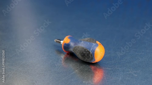 Screwdriver with an insulated handle for installing equipment. Soft focus. Close-up. Macro. 