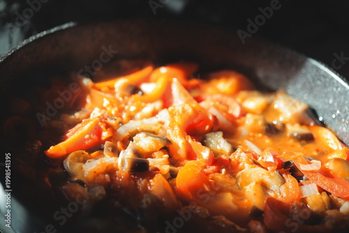 Photos Pan filled with abundant food sitting on a stovetop