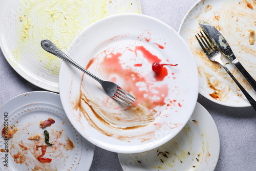 Konstfotografi Many dirty plates and cutlery on grey textured table, flat lay