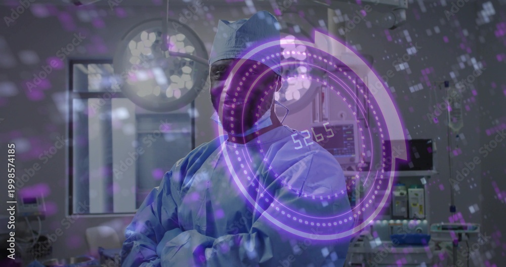 Obraz premium Standing adult surgeon wearing blue scrubs and cap in operating room, with vital monitor and HUD