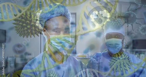 Standing medical duo wearing blue scrubs, bouffant caps, masks in OR with DNA virus overlays