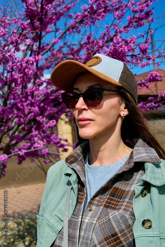 girl in a cap walks on the street