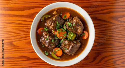Delicious beef stew with carrots and green peppers in bowl