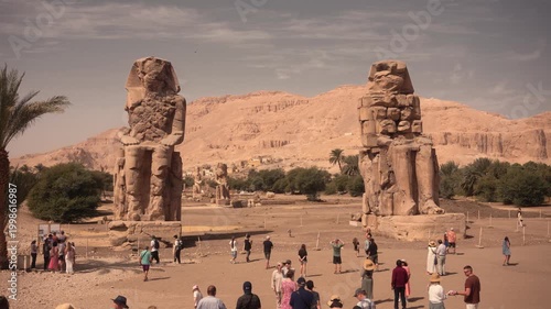 Colossi of Memnon, Luxor, Egypt – iconic ancient statues. Cinematic footage of the Colossi of Memnon in Luxor, Egypt, showcasing the massive ancient stone statues from various angles.