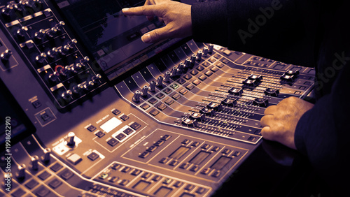 Mixing operation. Professional audio or sound engineers operating digital mixing consoles in studio or live mix perform. Sound control music production broadcasting mix and live event audio technology