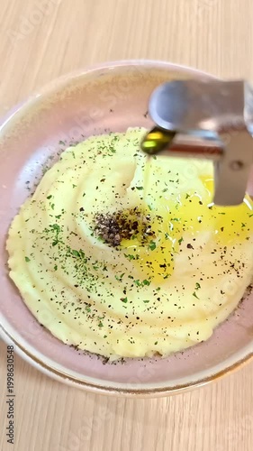 Pouring olive oil on creamy mashed potato, Fluffly Vegetarian Appetizer, Rustic Meal, Lunch Dinner Side Dish, Slow Motion