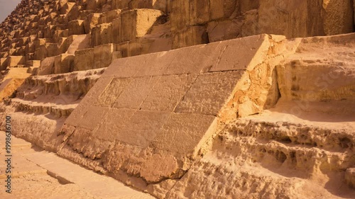 Close-up of original casing stones at base of Great Pyramid of Giza architectural detail sunrise Egypt. A close-up of a small section of the original casing stones at base of Great Pyramid of Giza
