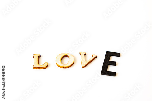 Obraz na płótnie valentines message love in wooden letters the type E is black and bigger than th