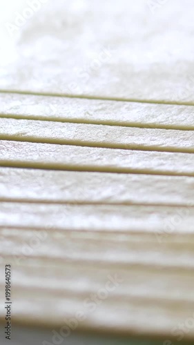 pastry chef cutting puff pastry dough on table in the kitchen. bakery preparation process.