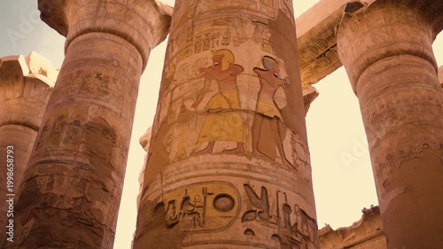 Hypostyle Hall columns, Temple of Karnak, Luxor. Ancient columns of the Hypostyle Hall at the Temple of Karnak in Luxor, Egypt. Sunlight streams between the columns