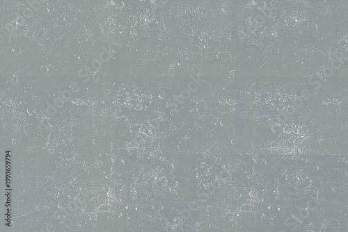 Valokuva Textured gray surface displays numerous fine white scratches and small speckles, creating a distressed and worn appearance