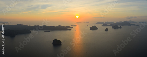 Dramatic limestone islands rise in Bacuit Bay, El Nido, at sunset. This area in the Philippines is a popular vacation destination due to its beautiful coral reefs, beaches, and hidden lagoons.