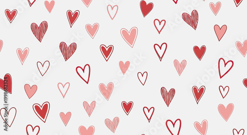 A scattering of hand-drawn red and pink hearts on a white background
