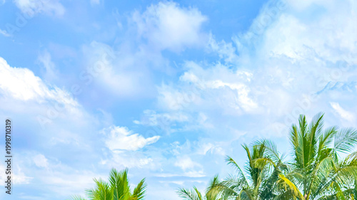 Bright blue sky with soft white clouds in clear weather