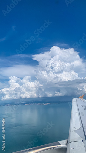 Dramatic cloud formation over sea with blue sky and horizon