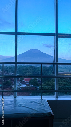Mountain view framed by window with clear sky and distant landscape