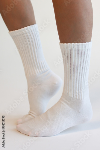 Female Legs Wearing White Ribbed Crew Socks Side View Minimal Studio Shot