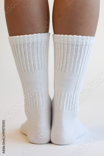 Woman Legs in White Cotton Crew Socks Standing Back View