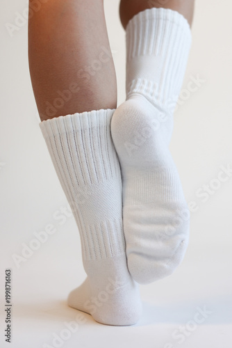 Woman Legs in White Cotton Crew Socks Standing Back View