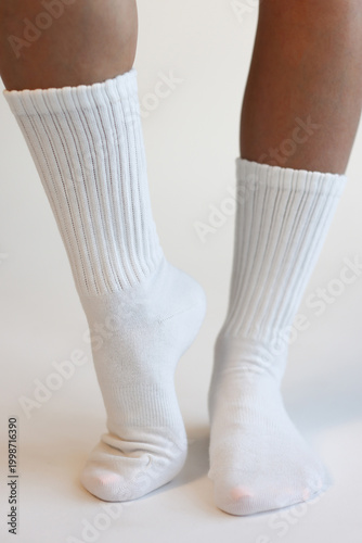 Female Legs Wearing White Ribbed Crew Socks Front View Minimal Studio Shot