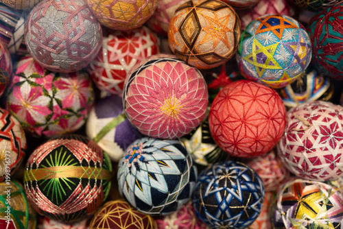 Bild auf Leinwand A colorful abundance of handcrafted temari balls; traditional Japanese embroidered thread spheres decorated with intricate geometric and floral patterns