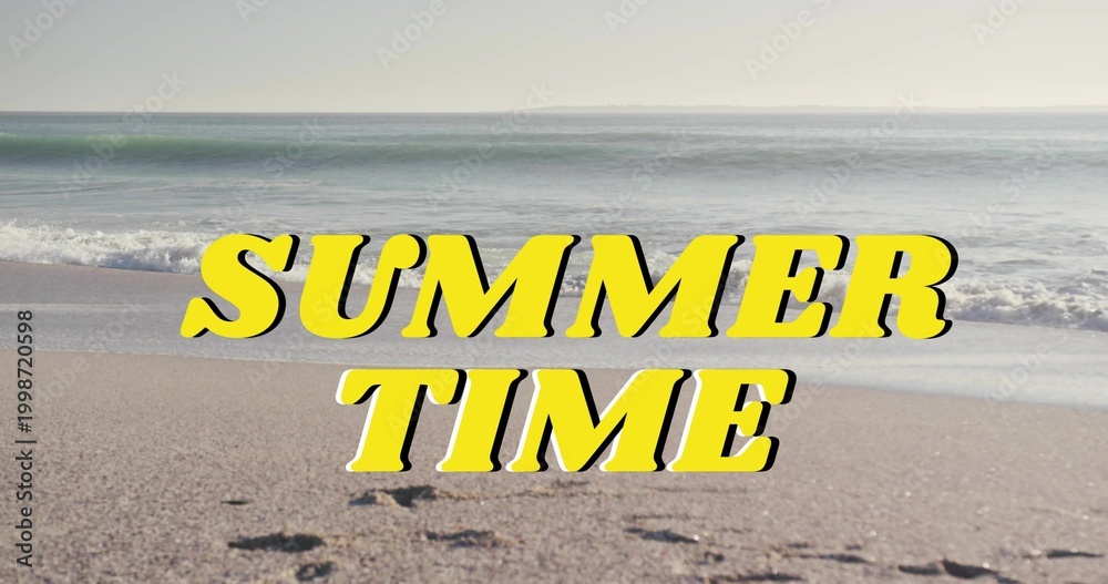 Fototapeta premium Displaying bold yellow SUMMER TIME graphic dominating sandy shoreline, showing footprints, waves