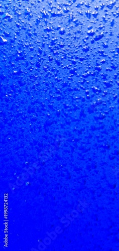 Abstract blue water texture with bubbles and droplets, gradient liquid background, macro underwater surface ideal for design, technology, and creative projects