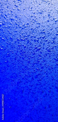 Abstract blue water texture with bubbles and droplets, gradient liquid background, macro underwater surface ideal for design, technology, and creative projects
