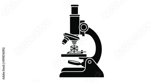 Microscope sits on a flat surface to represent scientific research and microscopic laboratory investigation.