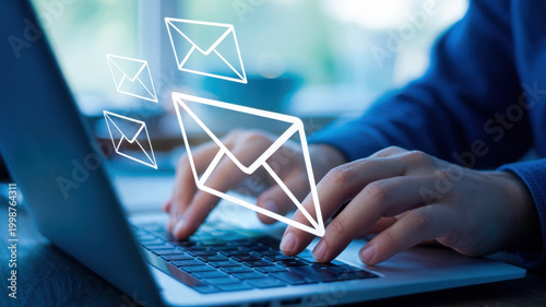 Person typing on a laptop keyboard with multiple email icons floating above, symbolizing digital communication, online messaging, and internet connectivity in a modern business or personal context