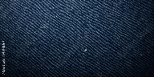A dark blue denim fabric texture provides a rough cotton material pattern for a fashion clothing backdrop or wallpaper design