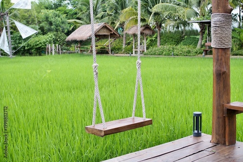 Valokuva A wooden swing sits in a rice field in Thailand
