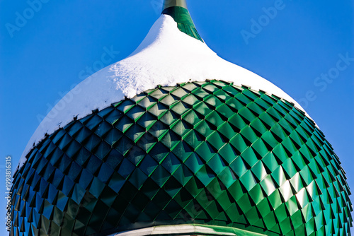 Photography Vibrant green onion dome of a Russian Orthodox church, blanketed with pristine snow against a clear winter sky