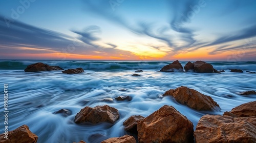 Long Exposure Golden Rocks at Twilight Coastline with Ethereal Blurred Ocean Waves