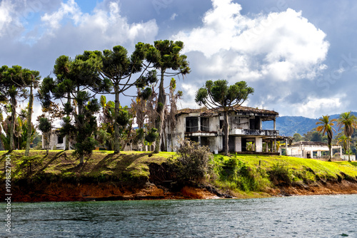 Bild auf Leinwand Abandoned house of Pablo Escobar stands on grassy cliff edge