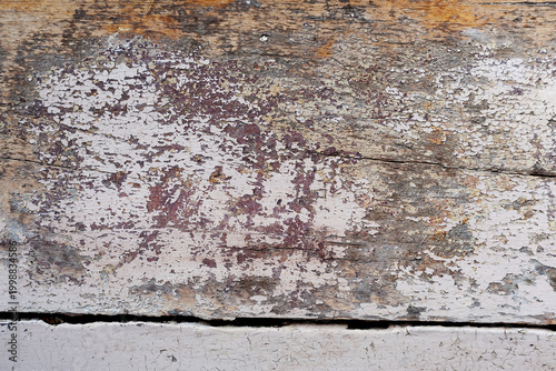 Fotografie Detail view of old fading paint and texture on the surface of a very wide wooden