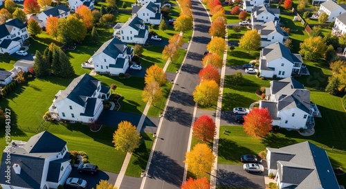 Aerial view of modern suburban neighborhood street with houses colorful autumn trees and well-maintained lawns in the USA