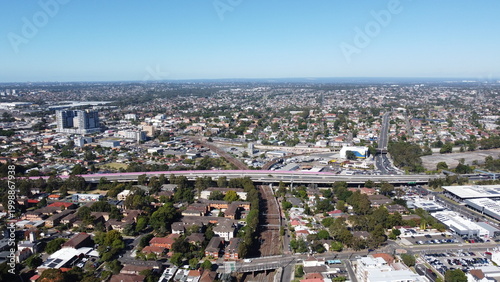 Quadro su tela Aerial view of suburbs commercial district and train station