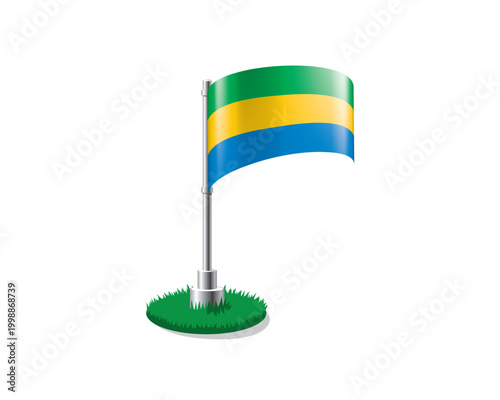 Gabonese flag on a flagpole mounted on the grass